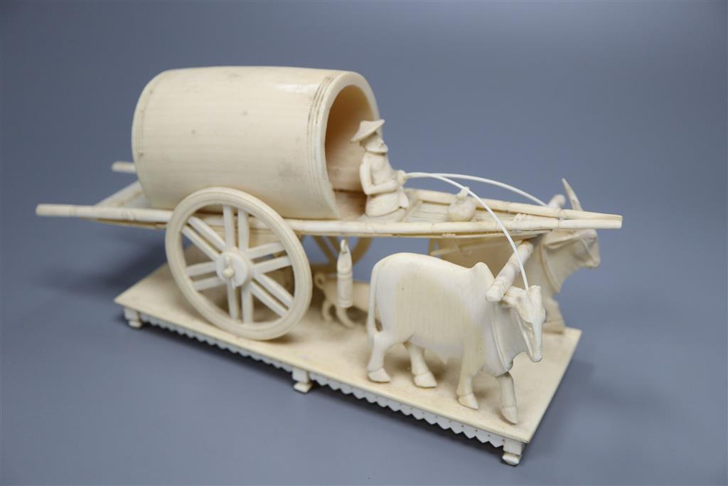 An early 20th century Indian ivory cart group and a Chinese boars tusk carving
